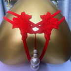 Red lace pearl-accent thong displayed on mannequin