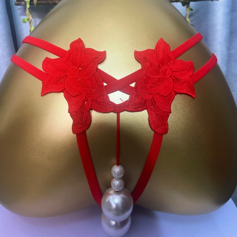 Red lace pearl-accent thong displayed on mannequin